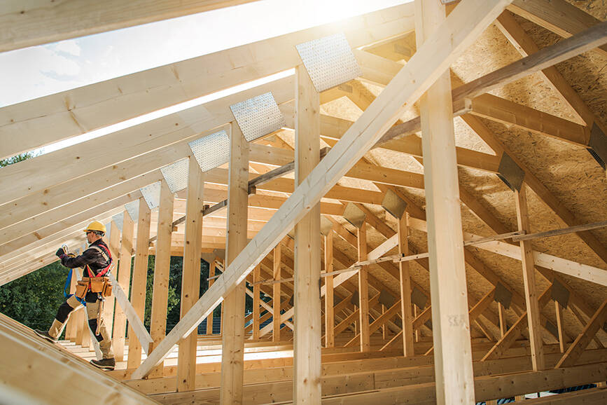 worker with house under construction