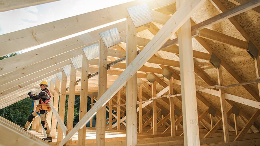 worker with house under construction