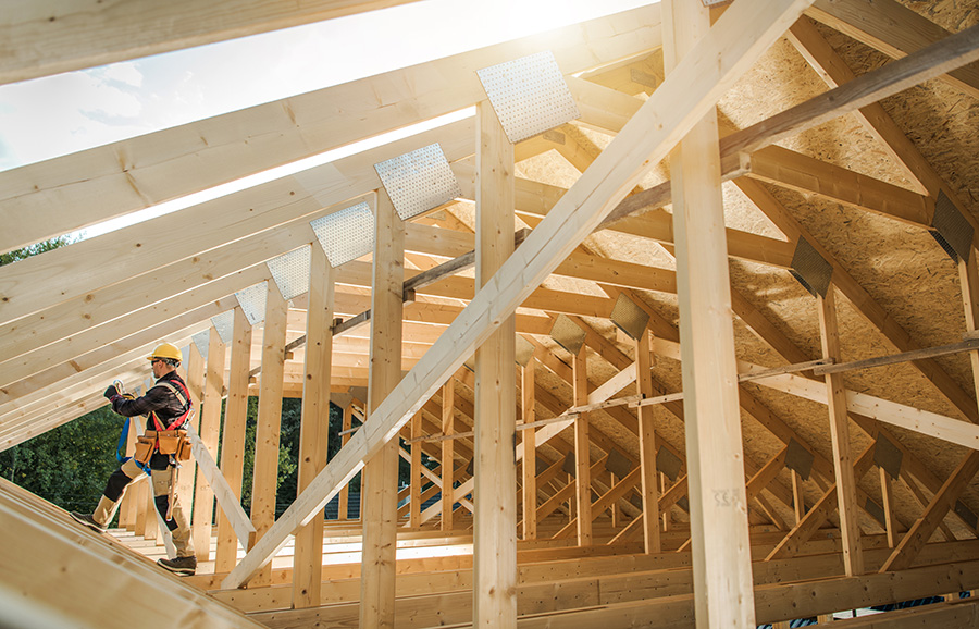 worker with house under construction